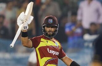 West Indies' skipper Shai Hope raises his bat as he celebrates his century in the 4th T20I against India at Rajiv Gandhi International Stadium, in Hyderabad.