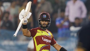 West Indies' skipper Shai Hope raises his bat as he celebrates his century in the 4th T20I against India at Rajiv Gandhi International Stadium, in Hyderabad.