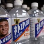 Bottled drinks by Eastroc Beverage with images of French soccer player Kylian Mbappe are displayed on a shelf at a store, in Beijing, China.