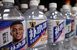 Bottled drinks by Eastroc Beverage with images of French soccer player Kylian Mbappe are displayed on a shelf at a store, in Beijing, China.