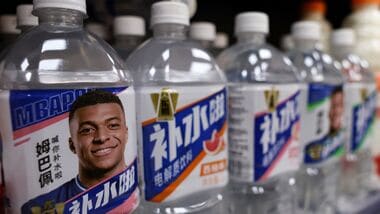 Bottled drinks by Eastroc Beverage with images of French soccer player Kylian Mbappe are displayed on a shelf at a store, in Beijing, China.