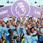 Manchester City manager Pep Guardiola celebrates with the trophy, players and staff after winning the Premier League title. (file photo)