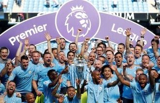 Manchester City manager Pep Guardiola celebrates with the trophy, players and staff after winning the Premier League title. (file photo)