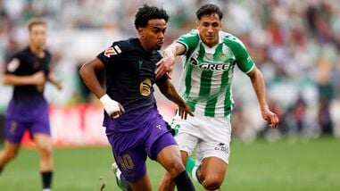 FC Barcelona's Lamine Yamal in action with Real Betis' Facundo Bernal
