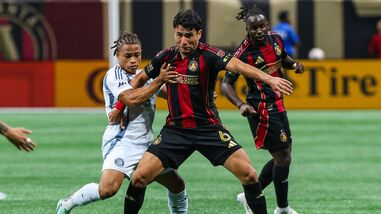Atlanta United defender Junior Alonso (6) defends the ball against Chicago Fire FC defender Leonardo Barroso (2) during the second half of their MLS match in Atlanta on Saturday.