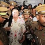 Prison officers escort Shiranthi Rajapaksa, the wife of Sri Lanka's former President Mahinda Rajapaksa, to a prison vehicle outside a magistrate's court in Colombo, Sri Lanka, Wednesday, Oct. 7, 2026. (AP Photo/Lahiru Harshana)