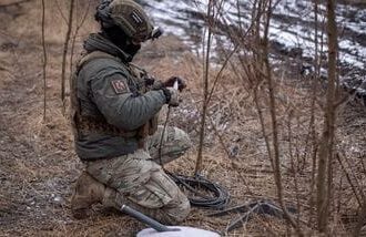 FILE PHOTO: A Ukrainian serviceman of 47th brigade prepares a Starlink satellite internet systems at his positions at a front line, amid Russia's attack on Ukraine, near the town of Avdiivka, recently captured by Russian troops in Donetsk region, Ukraine February 20, 2024. REUTERS/Inna Varenytsia/File Photo