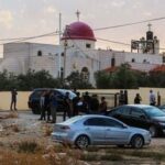 People and security forces gather outside a Greek Orthodox Church in the village of Hammoud in Jordan's Karak governorate following a shooting on October 23, 2026. (Photo by AFP)