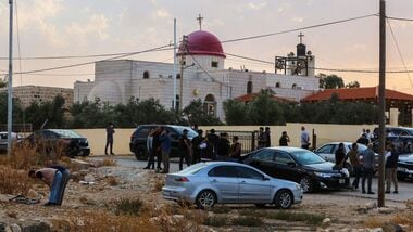 People and security forces gather outside a Greek Orthodox Church in the village of Hammoud in Jordan's Karak governorate following a shooting on October 23, 2026. (Photo by AFP)