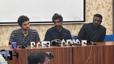 Former France international footballer Vikash Dhorasoo (C) speaks to the media at the Saltlake Stadium in Kolkata on Thursday.